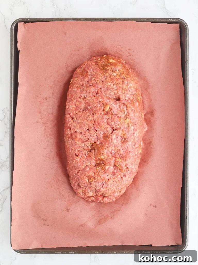 Smoked Meatloaf Recipe for Pellet Grills: Juicy, Flavorful Slice 9 Unbaked meatloaf on a baking sheet.
