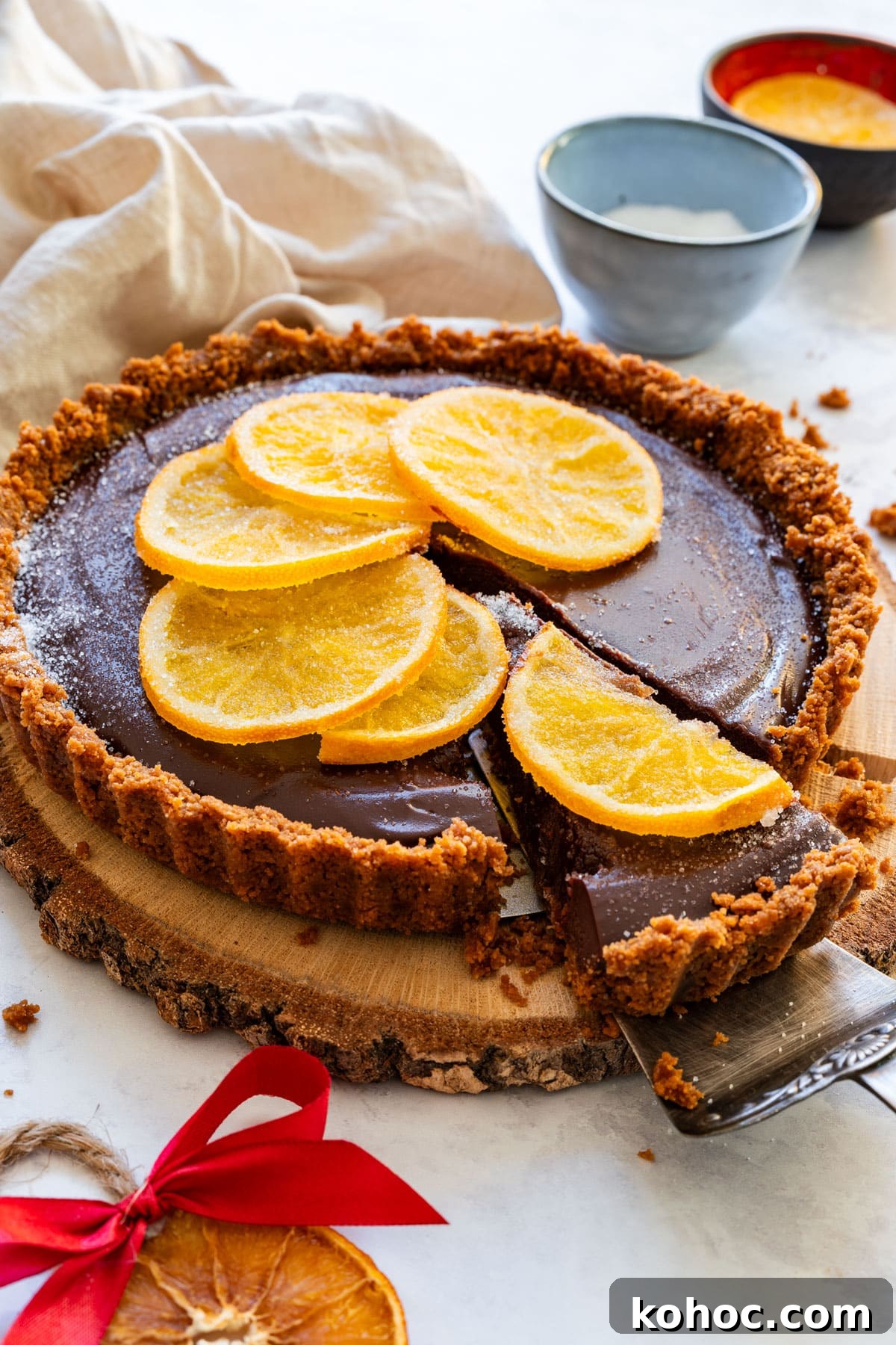 Decadent Chocolate Orange Tart Recipe with Zesty Ganache 2 Chocolate orange tart with Biscoff cookie crust and candied orange slices.