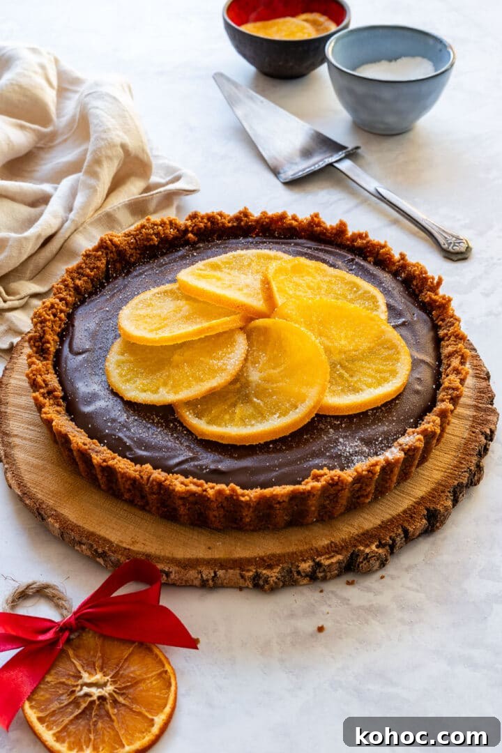 Decadent Chocolate Orange Tart Recipe with Zesty Ganache 9 Finished no-bake chocolate tart topped with candied orange slices.