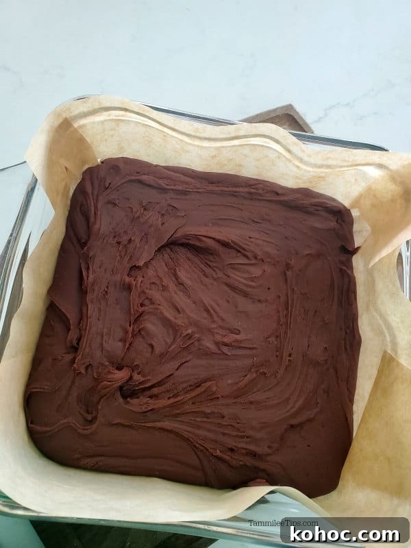Classic Carnation Condensed Milk Fudge Recipe (Video) 3 Carnation Famous chocolate fudge in a parchment lined baking dish