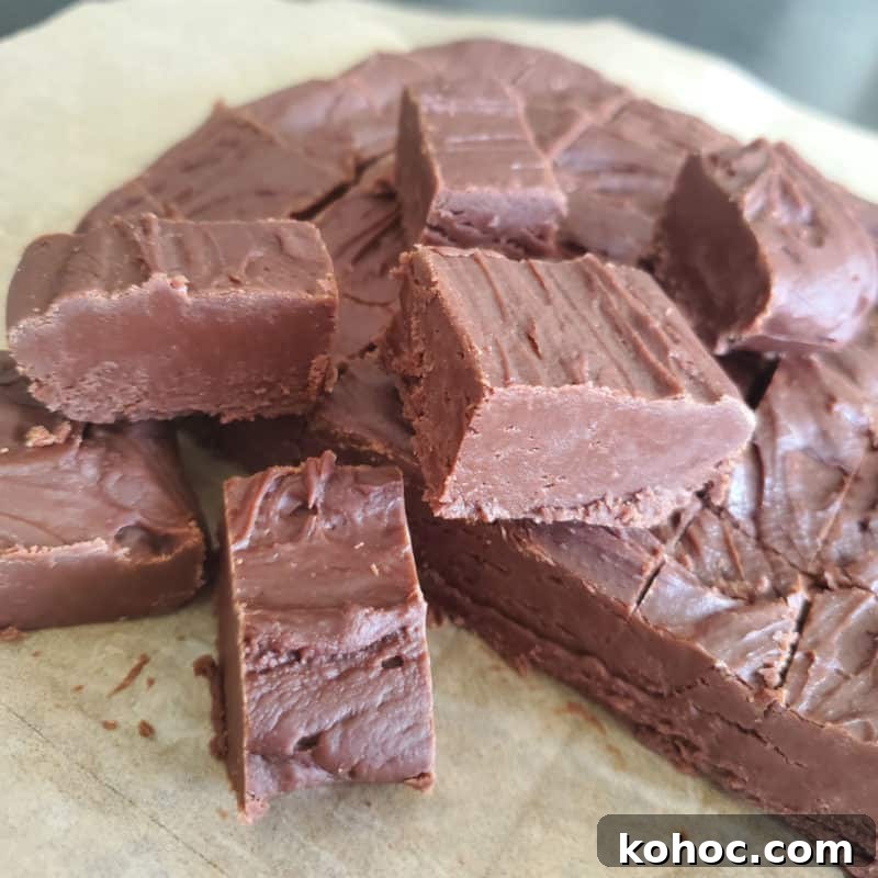 Classic Carnation Condensed Milk Fudge Recipe (Video) 4 Famous Carnation Fudge stacked on parchment paper