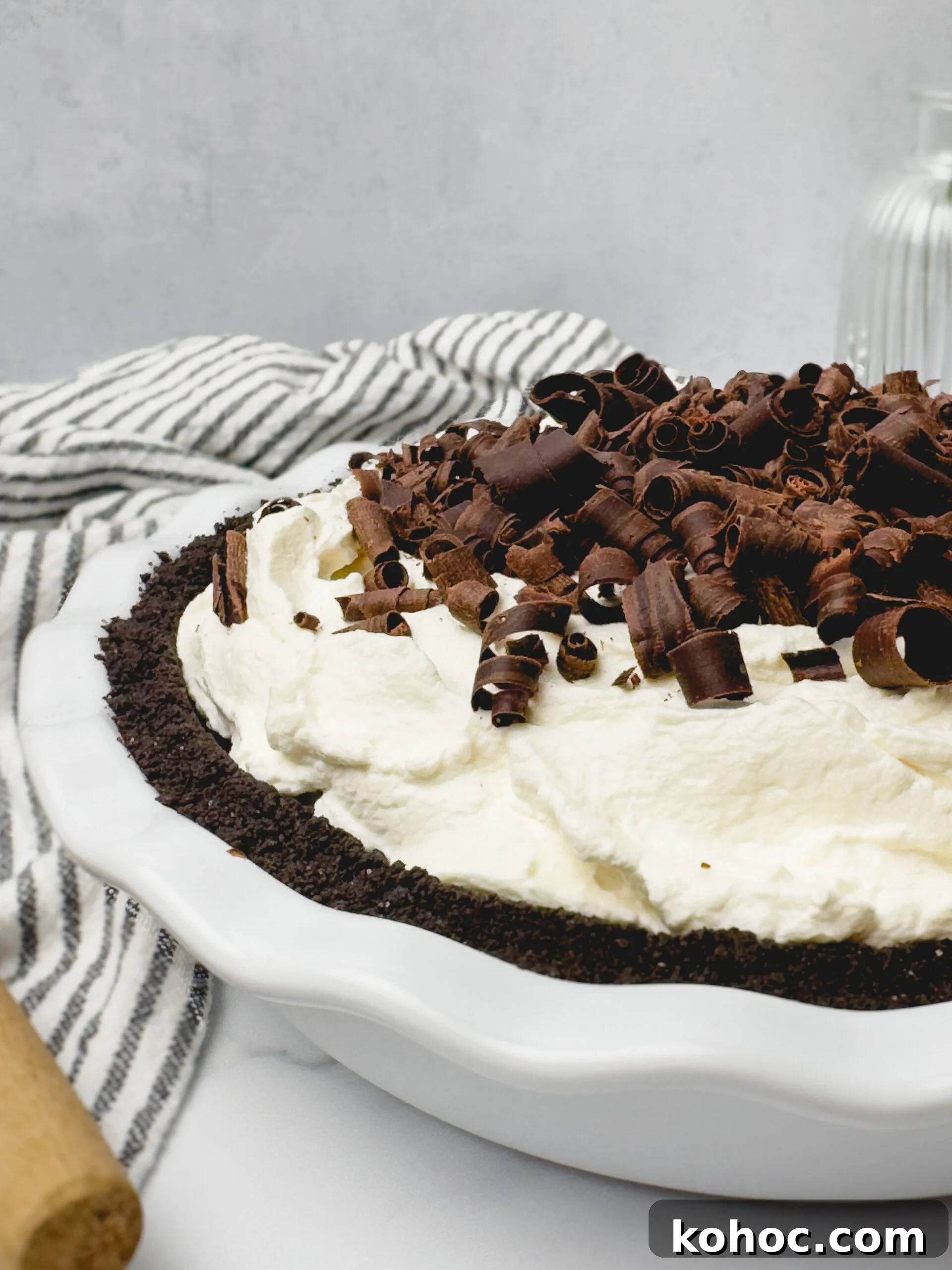 Decadent Chocolate Cream Pie Recipe with Silky Ganache Filling 7 Slice of pie with whipped cream