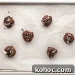 Oreo Brownie Mix Cookie Recipe — Fudgy Oreo Cookies 8 Cookie dough rolled into balls on a lined baking sheet.