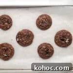 Oreo Brownie Mix Cookie Recipe — Fudgy Oreo Cookies 9 Baked cookies on a lined baking sheet.