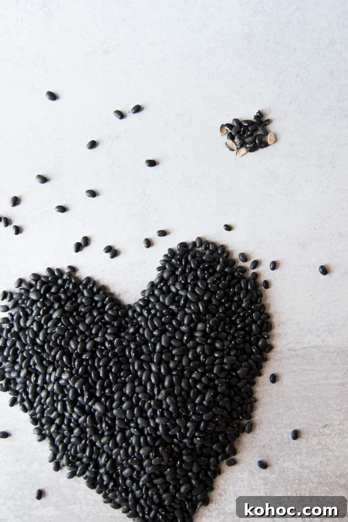 Black beans shaped into a heart with some beans sprinkled around it
