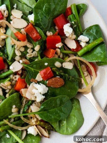 Spinach, asparagus and red pepper salad on a plate.