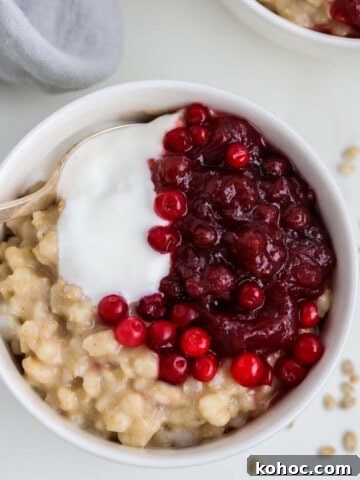 Close up of a bowl of Creamy Barley Breakfast Porridge with a spoon.