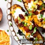 Crispy Air Fryer Potato Skins with Cheddar & Bacon 12 tgif loaded potato skins on a plate
