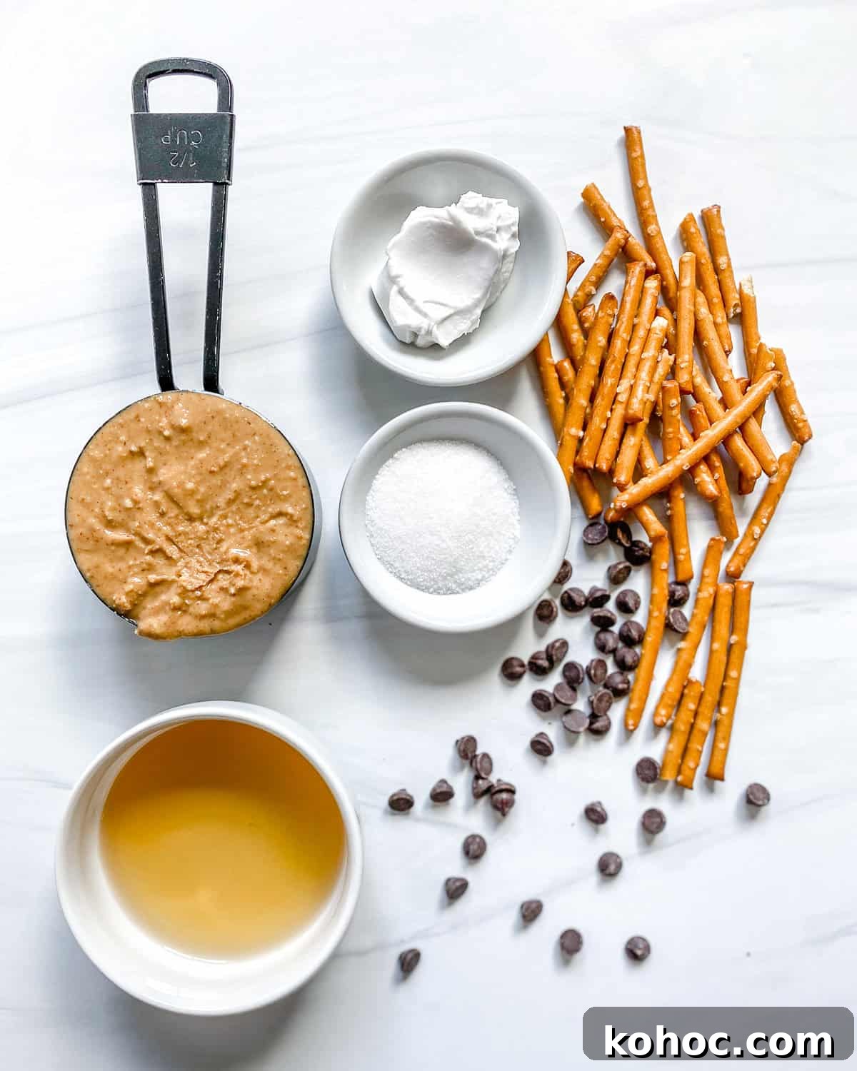 ingredients for peanut butter spiders on a white surface