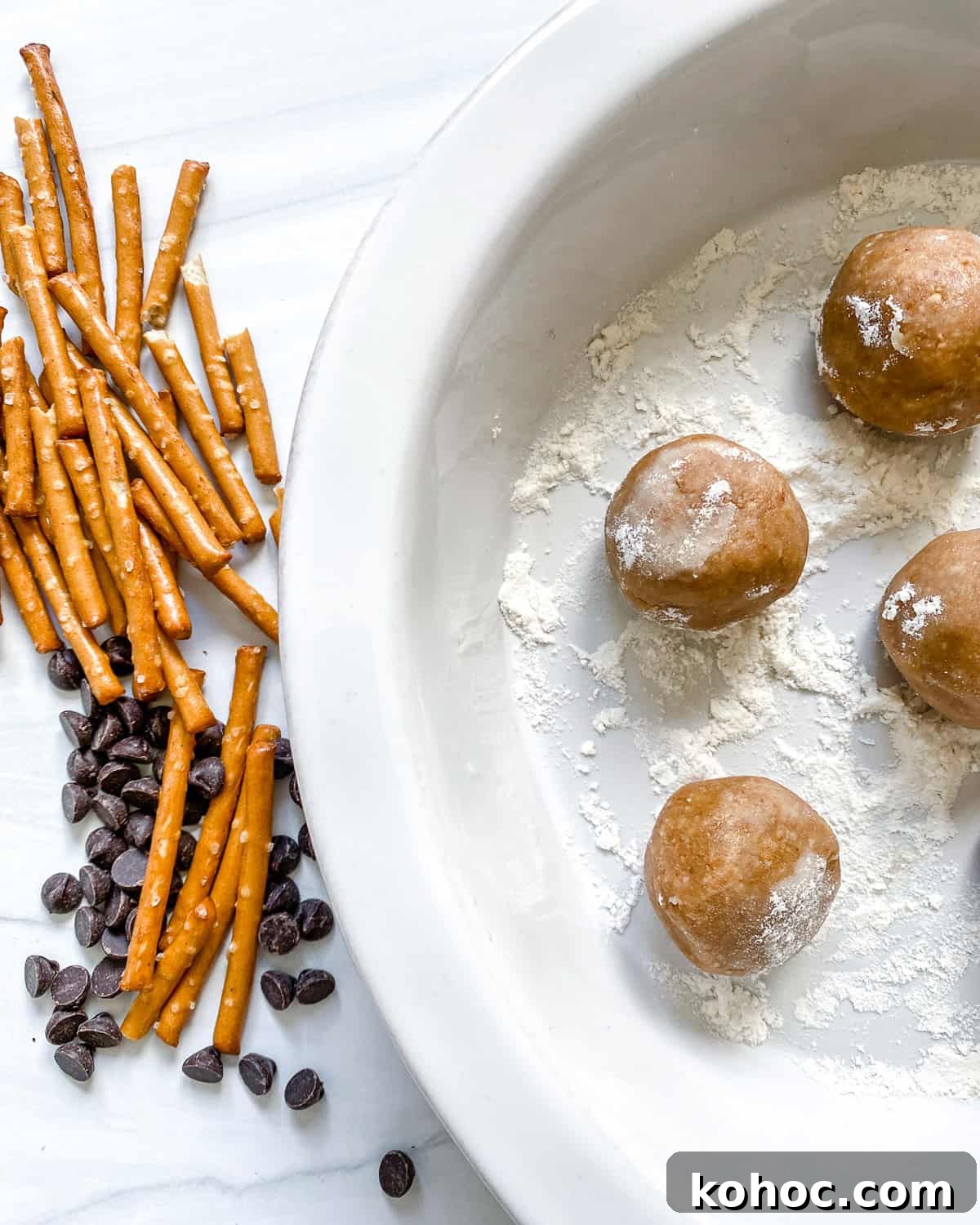 process shot showing peanut butter balls alongside pretzels and vegan chocolate chips