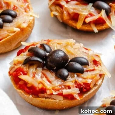 Completed Mini Spider Pizza [Bagel Bites] on a white surface.