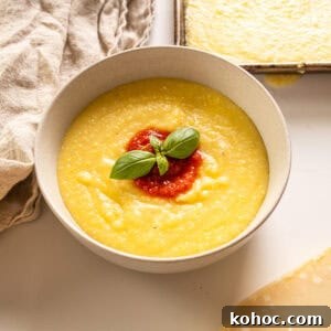 Creamy Italian Polenta Recipe 9 Creamy polenta in a bowl topped with marinara and basil.