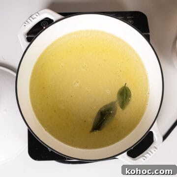 Creamy Italian Polenta Recipe 4 Whisking together cold water, olive oil, salt, bay leaves, and polenta.