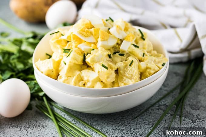 Potato salad in a stack of white bowls.