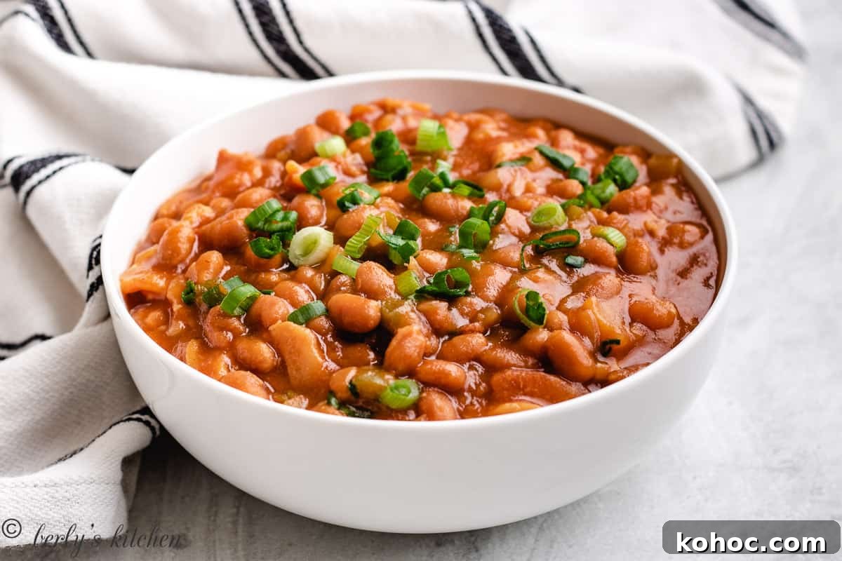 Large white bowl filled with slow cooker baked beans.