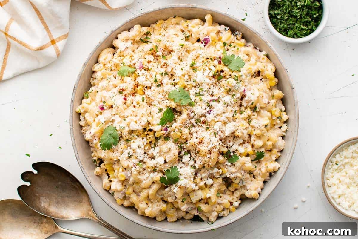 Top down view Mexican street corn pasta salad in a serving bowl.