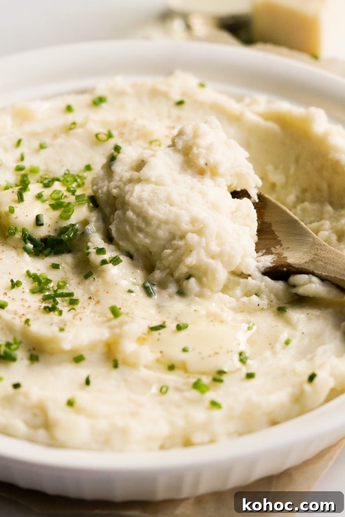 Truffle Mashed Potatoes Recipe: Creamy Garlic Parmesan Mash 13 truffle mashed potatoes in a dish with a wooden spoon scooping some out