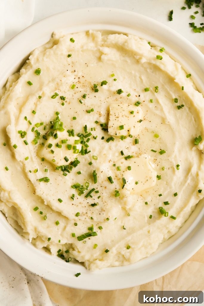 Truffle Mashed Potatoes Recipe: Creamy Garlic Parmesan Mash 14 overhead shot of mashed potatoes topped with truffle oil, fresh chives, butter, and pepper