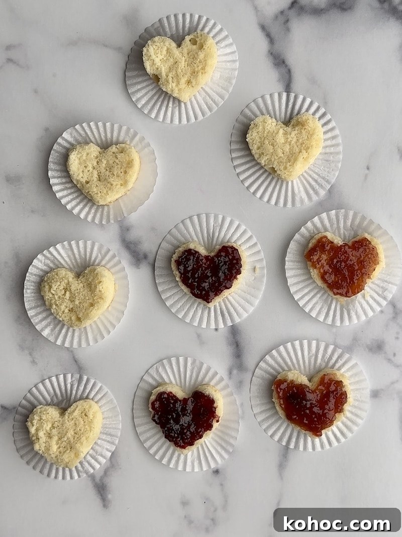 Mini Heart Cakes: Two Simple Ways to Make Adorable Treats 6 The bottom layer of several small heart cakes with cake filling on them.