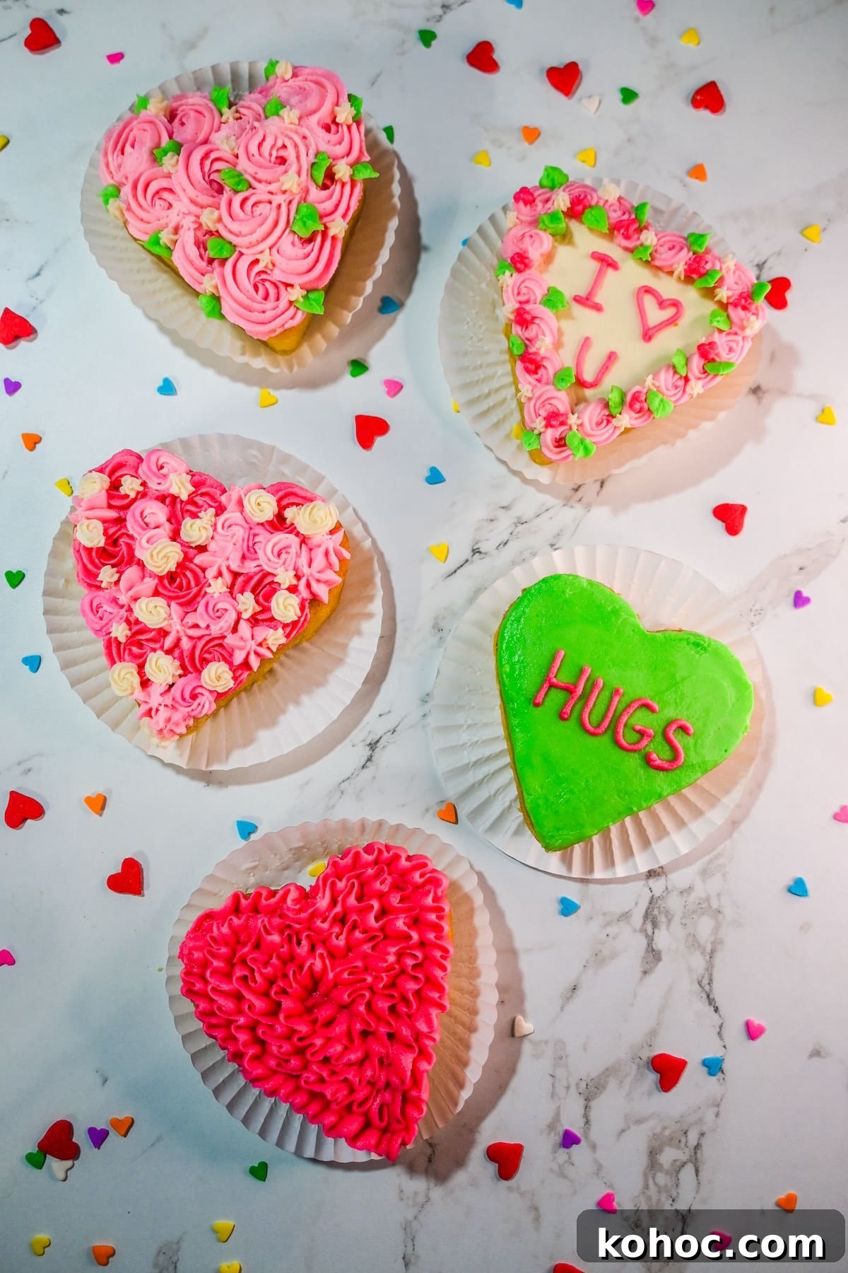 Mini Heart Cakes: Two Simple Ways to Make Adorable Treats 8 Mini heart cakes decorated with colorful buttercream designs.