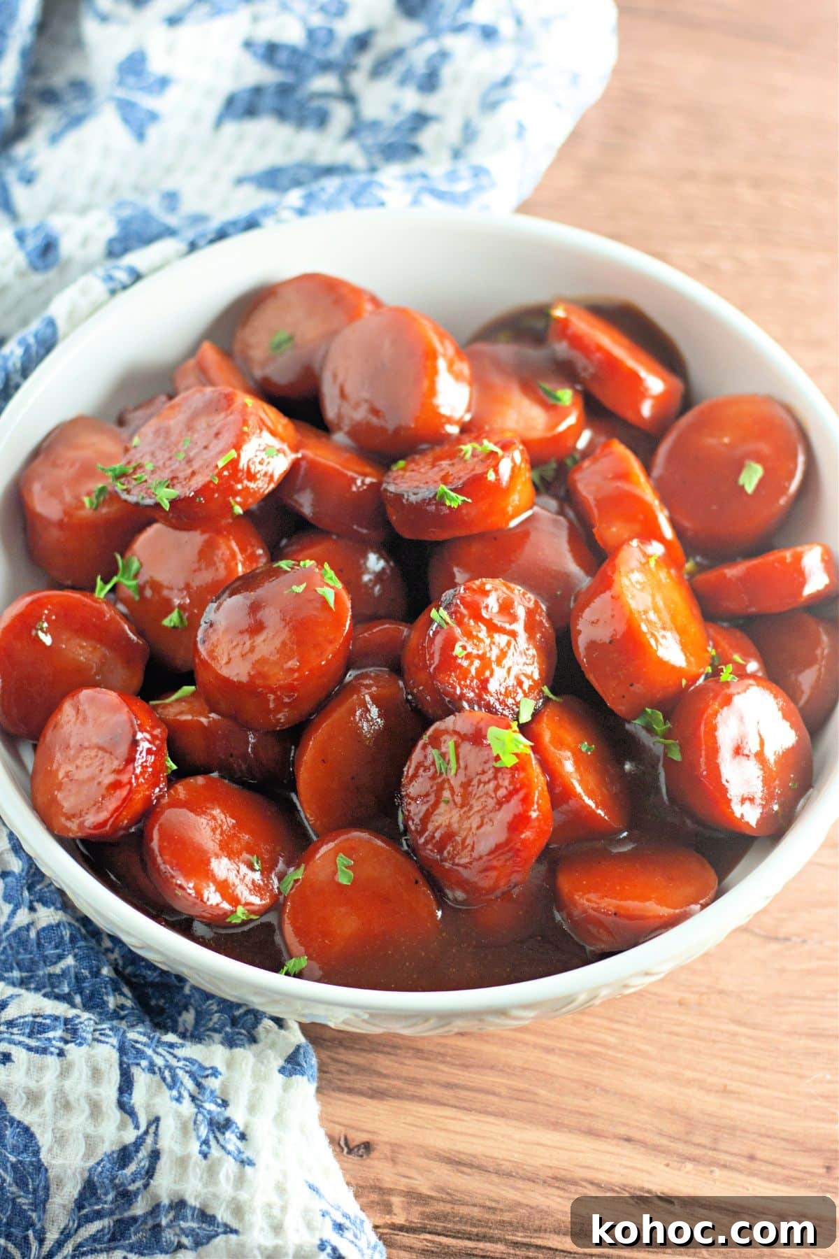 Oven-Baked BBQ Kielbasa Roast: Sweet Glazed Sausage Recipe 3 White bowl full of baked bbq kielbasa.