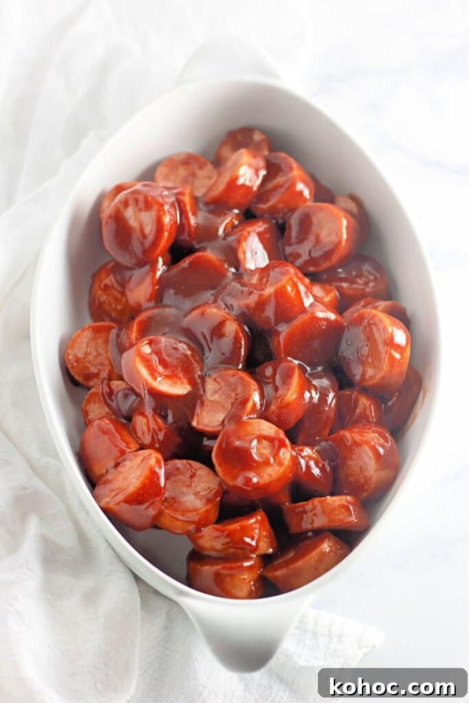 Oven-Baked BBQ Kielbasa Roast: Sweet Glazed Sausage Recipe 7 Smoked sausage in barbecue sauce in a casserole dish.