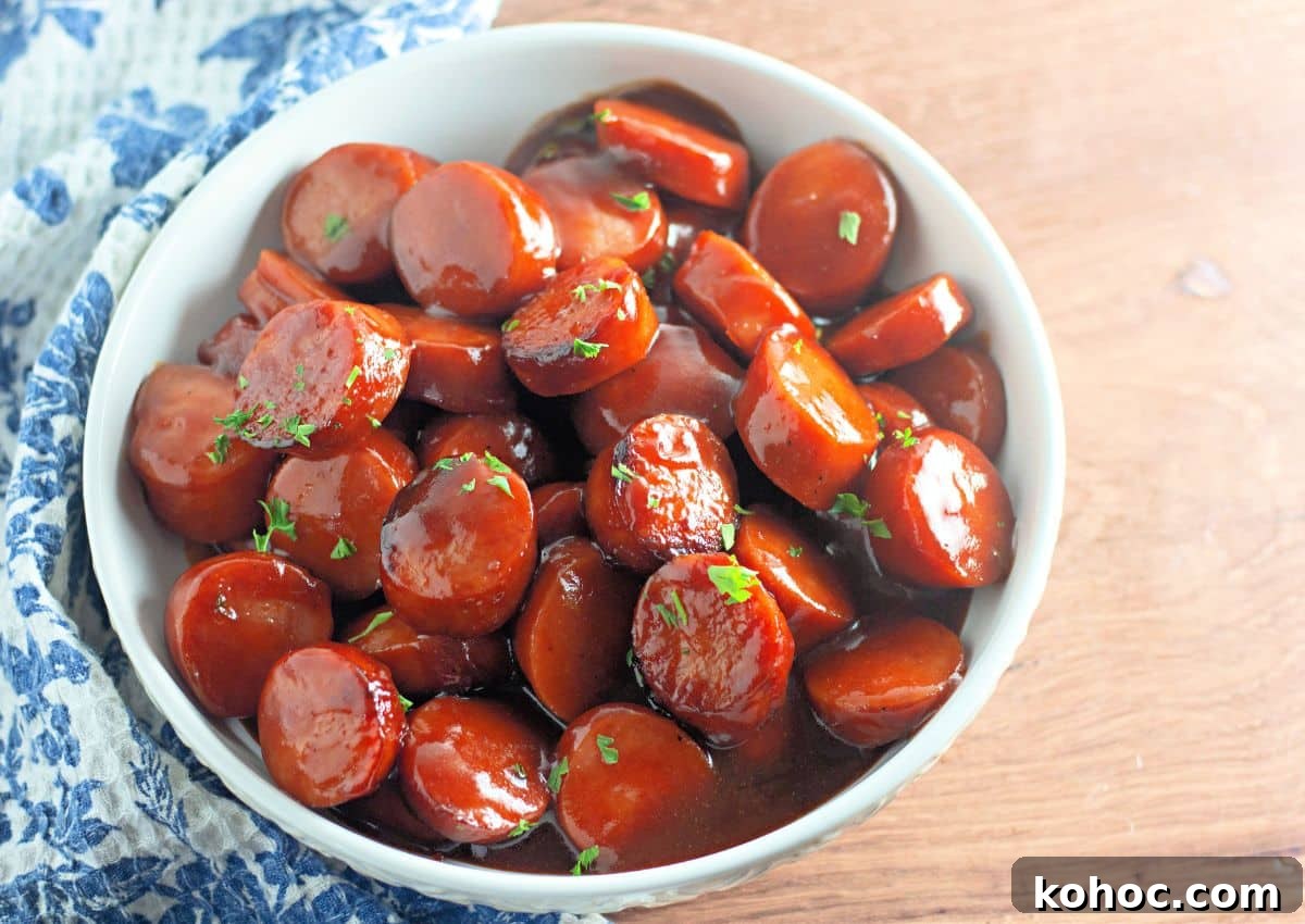 Oven-Baked BBQ Kielbasa Roast: Sweet Glazed Sausage Recipe 9 White bowl full of baked bbq kielbasa.
