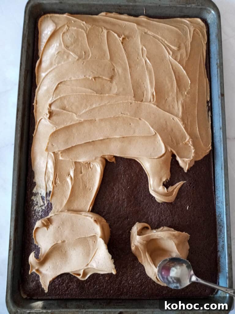 Amish-Style Reese’s Peanut Butter Bars Recipe for Dessert 4 spreading peanut butter over the chocolate cake