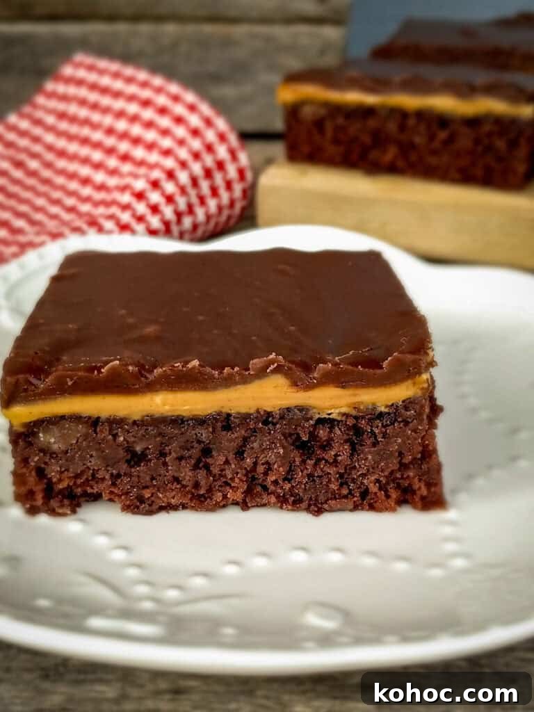 Amish-Style Reese’s Peanut Butter Bars Recipe for Dessert 7 Reese's bar with boiled frosting on top on a small plate.