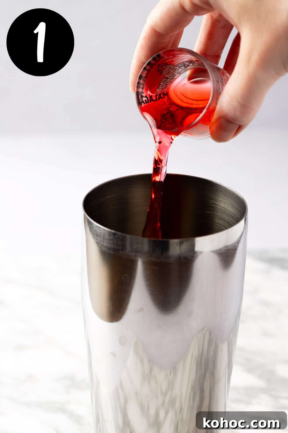 Romantic Love Potion Cocktail Recipe for Date Night 4 Pouring raspberry syrup into a cocktail shaker.