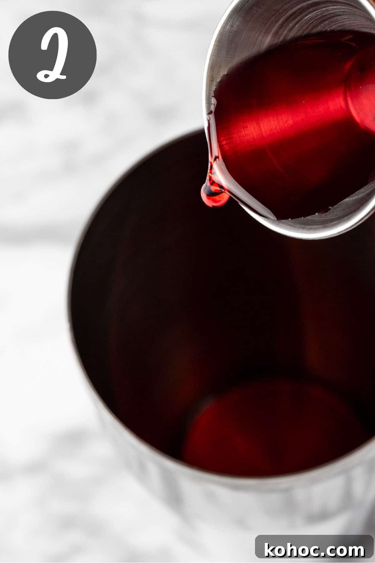 Romantic Love Potion Cocktail Recipe for Date Night 5 Pouring the cranberry juice into a cocktail shaker.