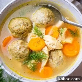Classic Matzo Ball Soup Recipe: Cozy Homemade Comfort Soup 9 meatball soup with carrots in a bowl.