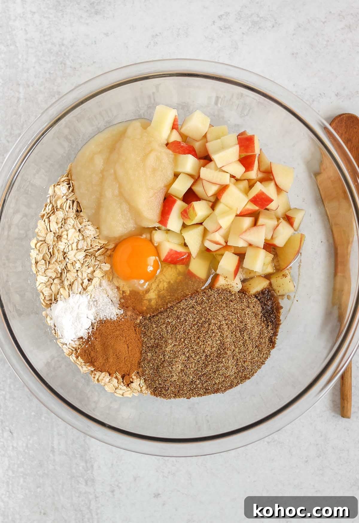 Apple Cinnamon Baked Oatmeal Recipe for Cozy Breakfasts 4 Ingredients for apple cinnamon baked oatmeal in a large glass mixing bowl before being mixed.