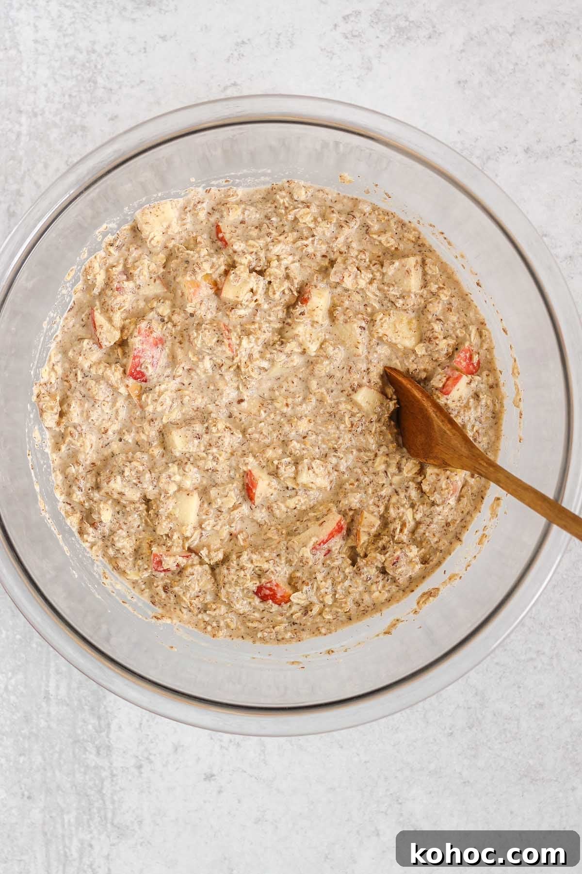 Apple Cinnamon Baked Oatmeal Recipe for Cozy Breakfasts 5 Oatmeal mix with apples in a large glass mixing bowl.