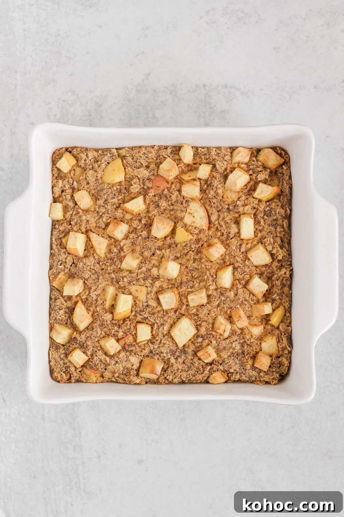 Apple Cinnamon Baked Oatmeal Recipe for Cozy Breakfasts 7 Baked apple cinnamon oatmeal in a square white baking dish.
