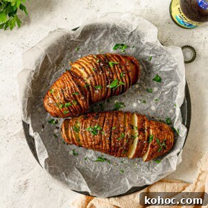 Crispy Air Fryer Hasselback Potatoes with Garlic and Herbs 11 Hasselback potatoes next to two beer bottles.