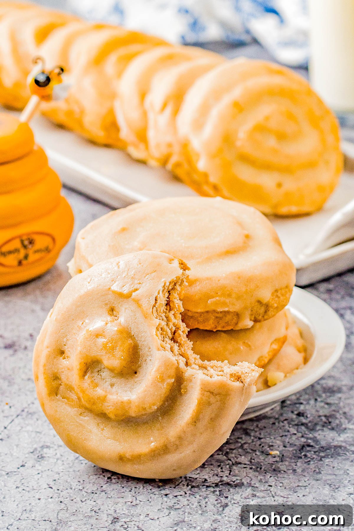 Honey Bun Cookies (Crumbl Cookies Copycat) - Soft and chewy with a warm buttery cinnamon flavor, these cookies resemble a classic Honey Bun with their fun swirl on top! The sweet honey glaze makes them IRRESISTIBLE! This EASY Crumbl Cookies copycat recipe will become a family FAVORITE! 