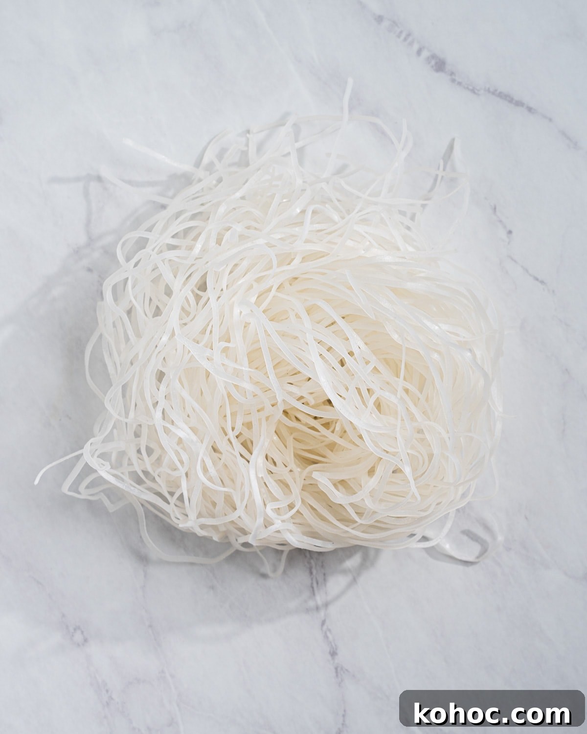Perfect Rice Noodles: How to Cook Them Without Overcooking 13 fresh rice noodles on a marble surface.