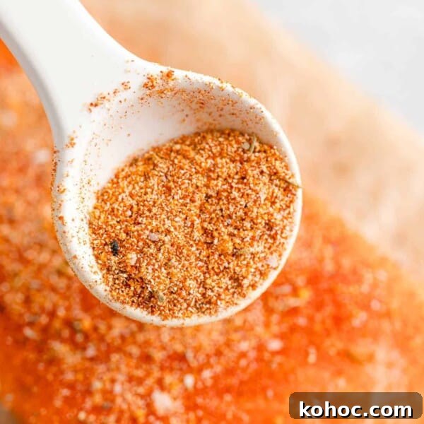 Salmon seasoning being sprinkled on salmon.
