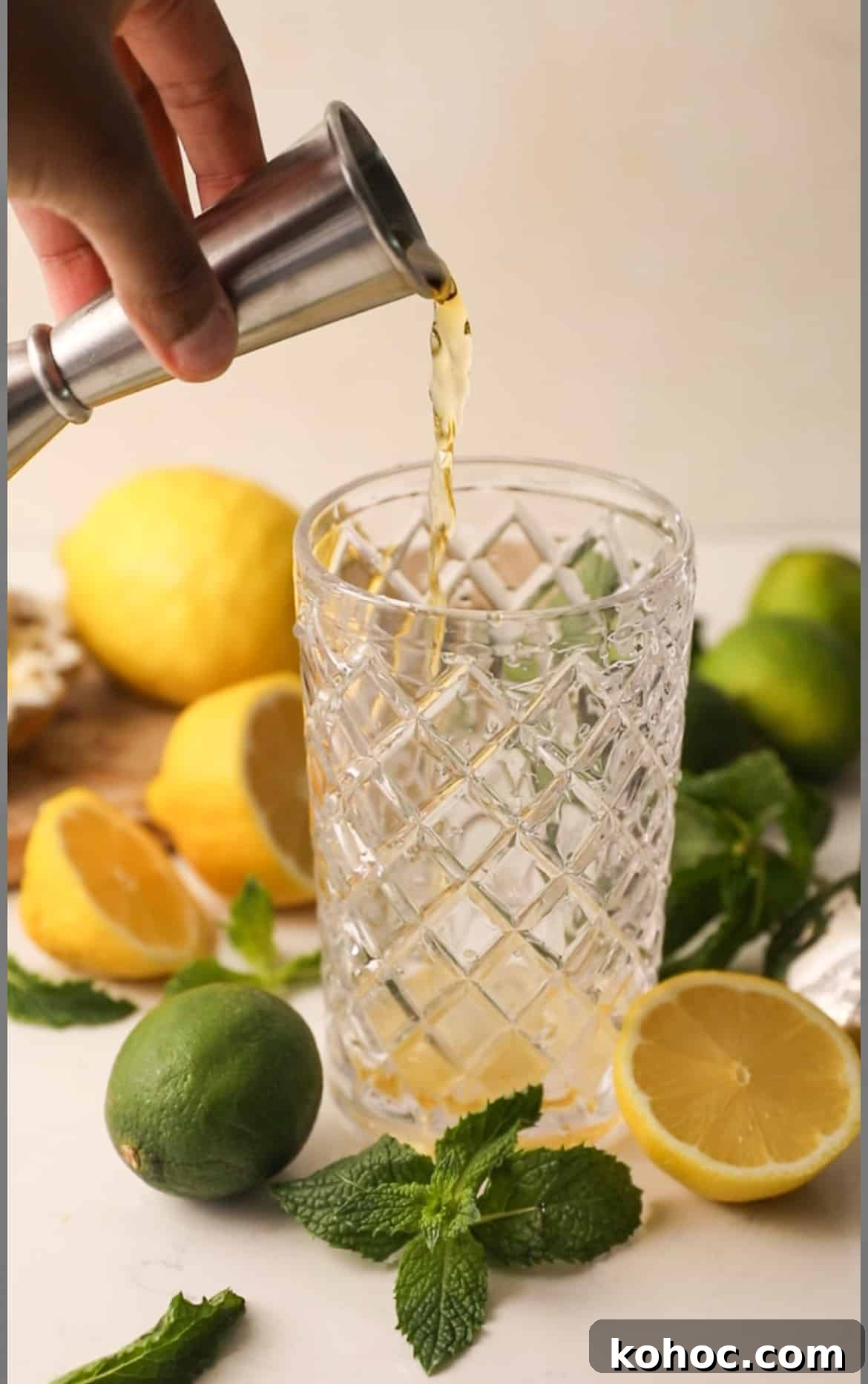 pouring ingredients for green tea shot into a cocktail shaker
