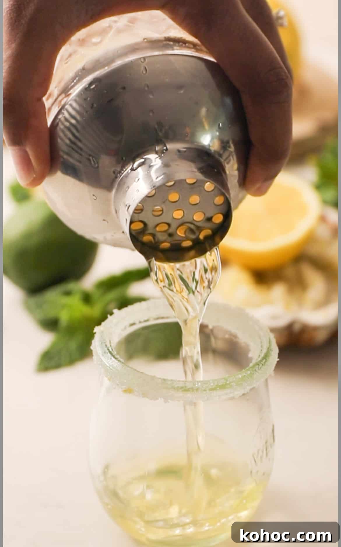 pouring green tea shots into a shot glass.