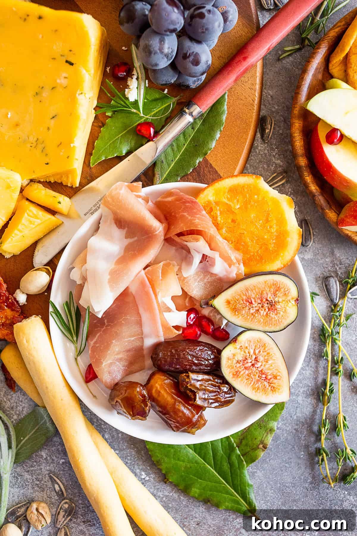 Autumn Cheese Board Ideas for Entertaining 3 Prosciutto, figs, and dates on a small plate.