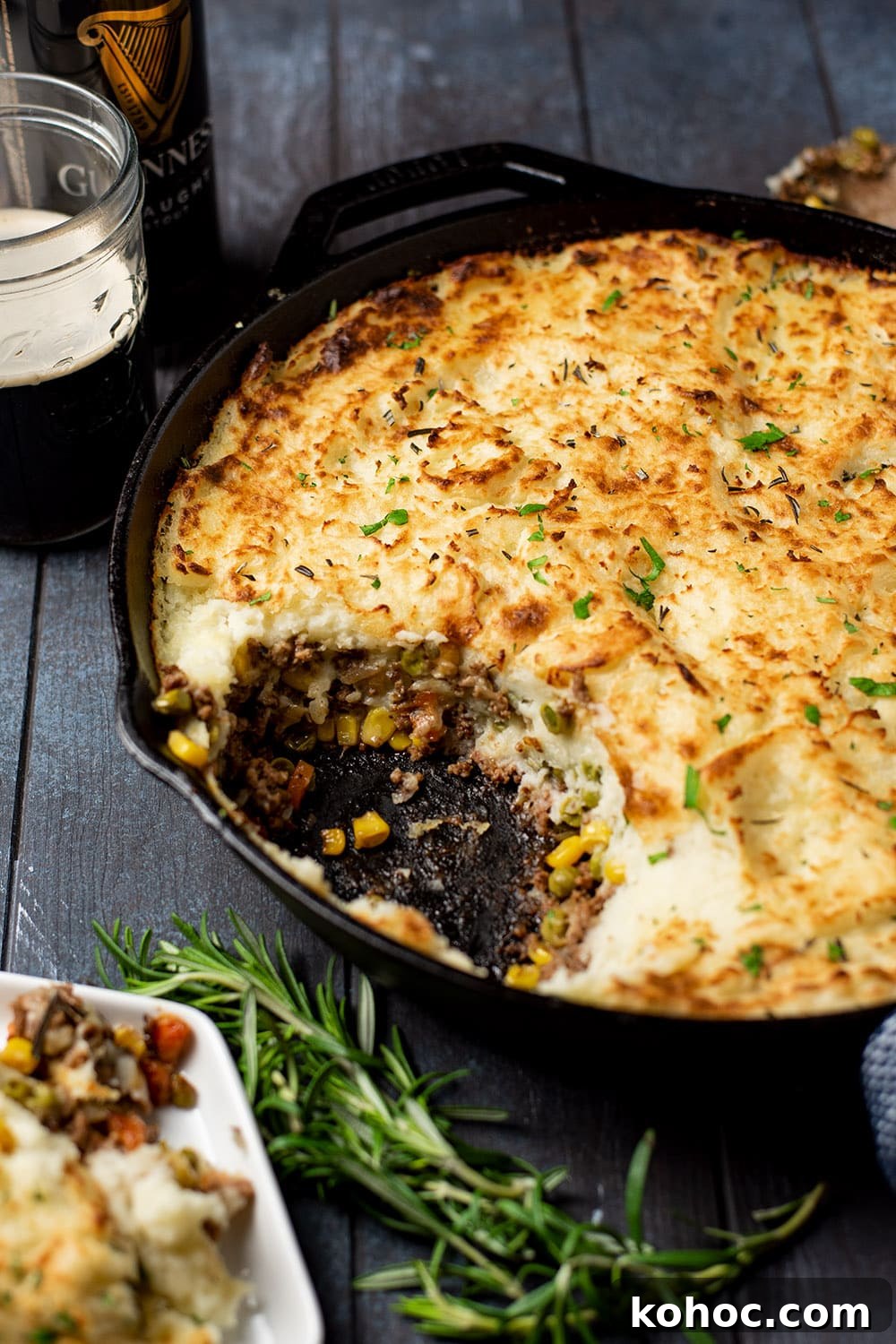 Skillet Shepherd's Pie with Crispy Potato Topping 3 Classic Shepherd's pie in a cast iron skillet with a scoop removed, revealing minced meat, carrots, corn, and a thick layer of golden mashed potatoes.