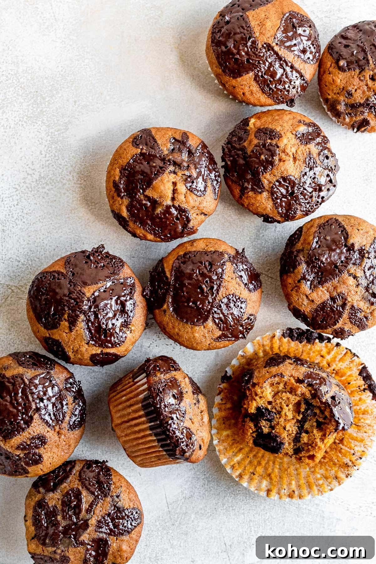 Moist Pumpkin Chocolate Chip Muffins 7 pumpkin chocolate chip muffins scattered on table