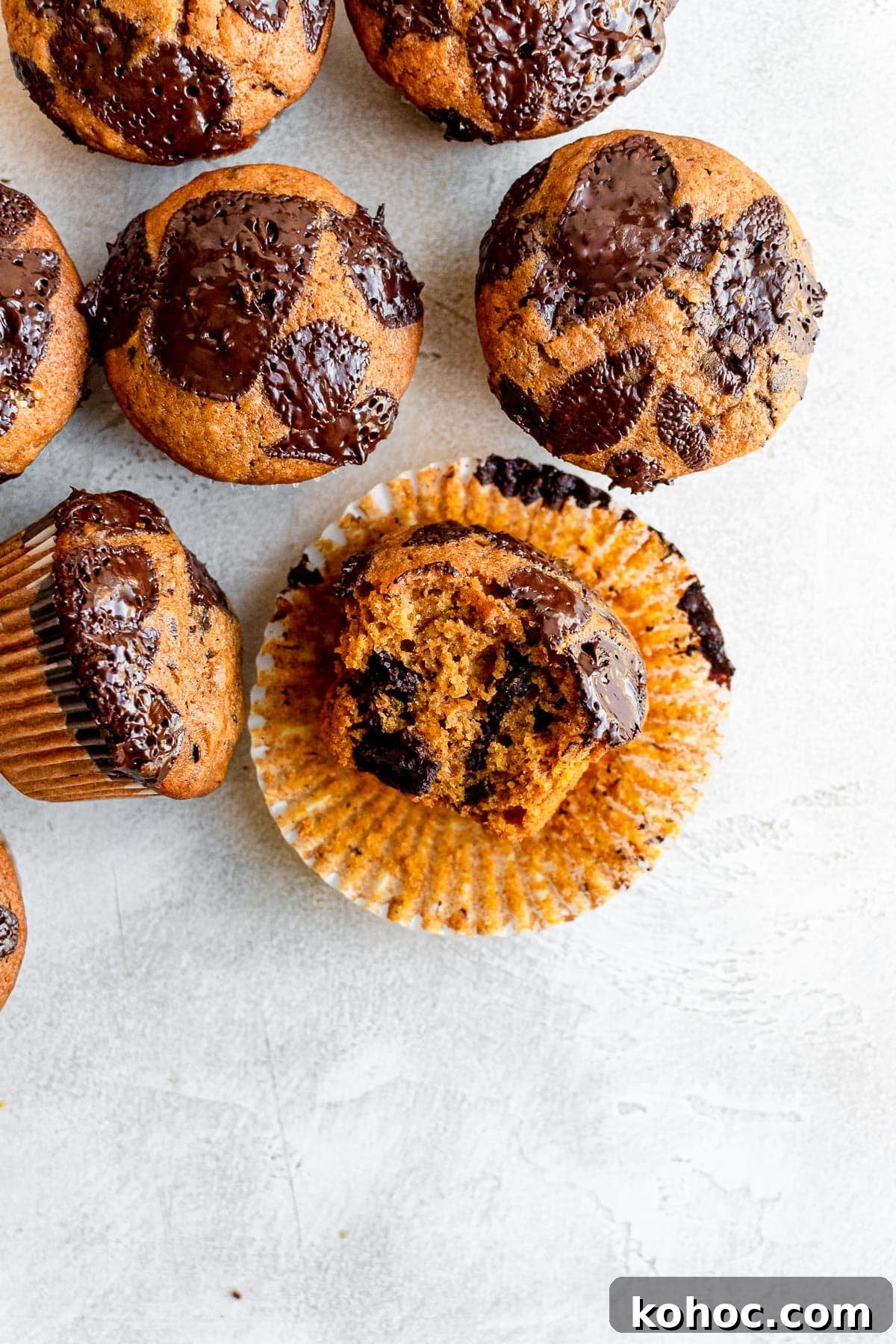 Moist Pumpkin Chocolate Chip Muffins 8 overhead of muffins one with bite missin