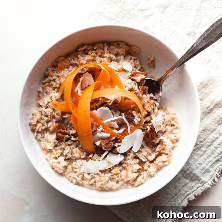gluten free carrot cake overnight oats in a bowl topped with shredded carrots,