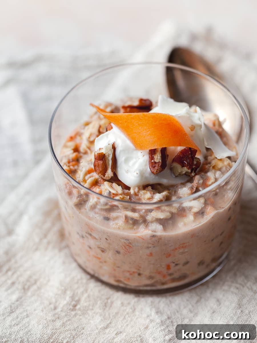 carrot cake overnight oats in a cute glass topped with greek yogurt, carrots and pecans 