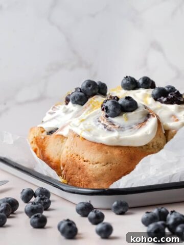 gluten free blueberry cinnamon rolls topped with lemon cream cheese frosting and fresh blueberries and lemon zest, blueberry sweet rolls