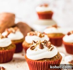 sweet potato cupcake topped with marshmallow frosting and chopped pecans
