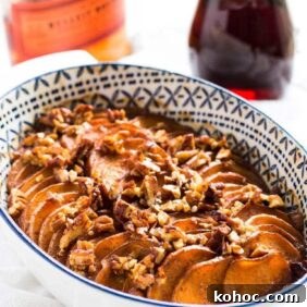bourbon maple sweet potato casserole with pecans on top in a dish.